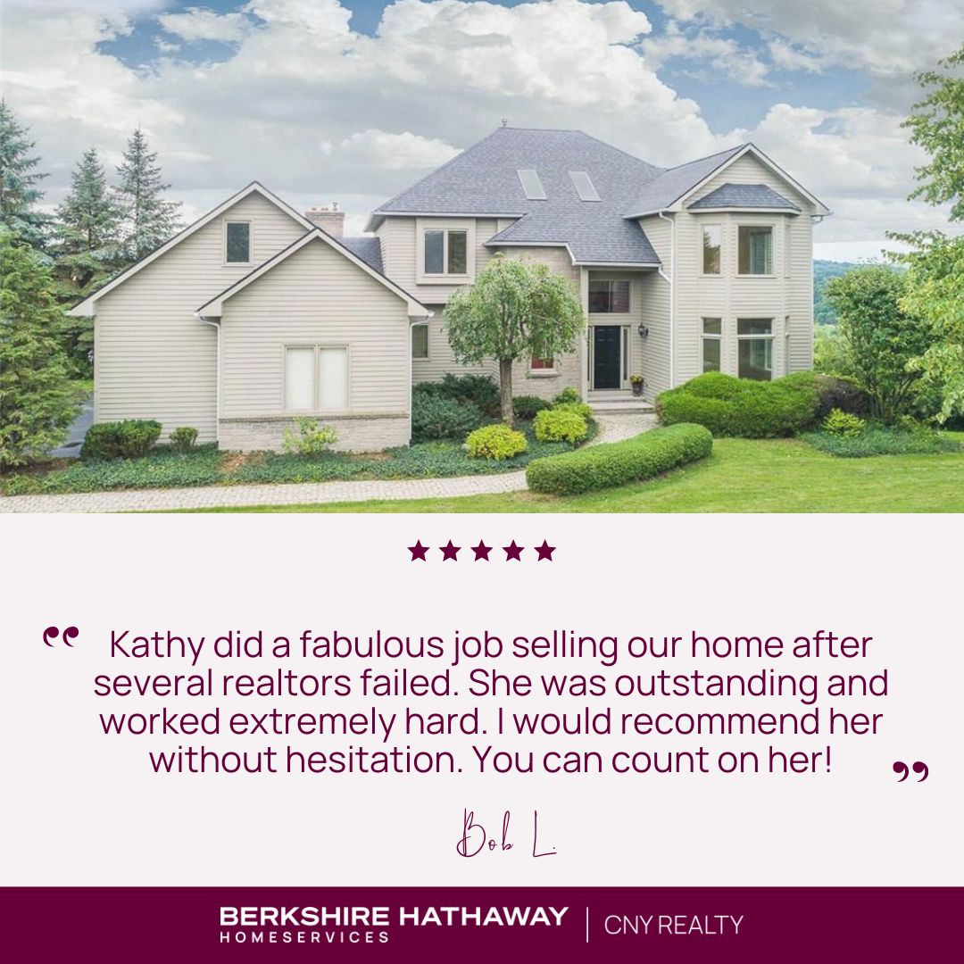 Exterior of a large grey home with a testimonial underneath