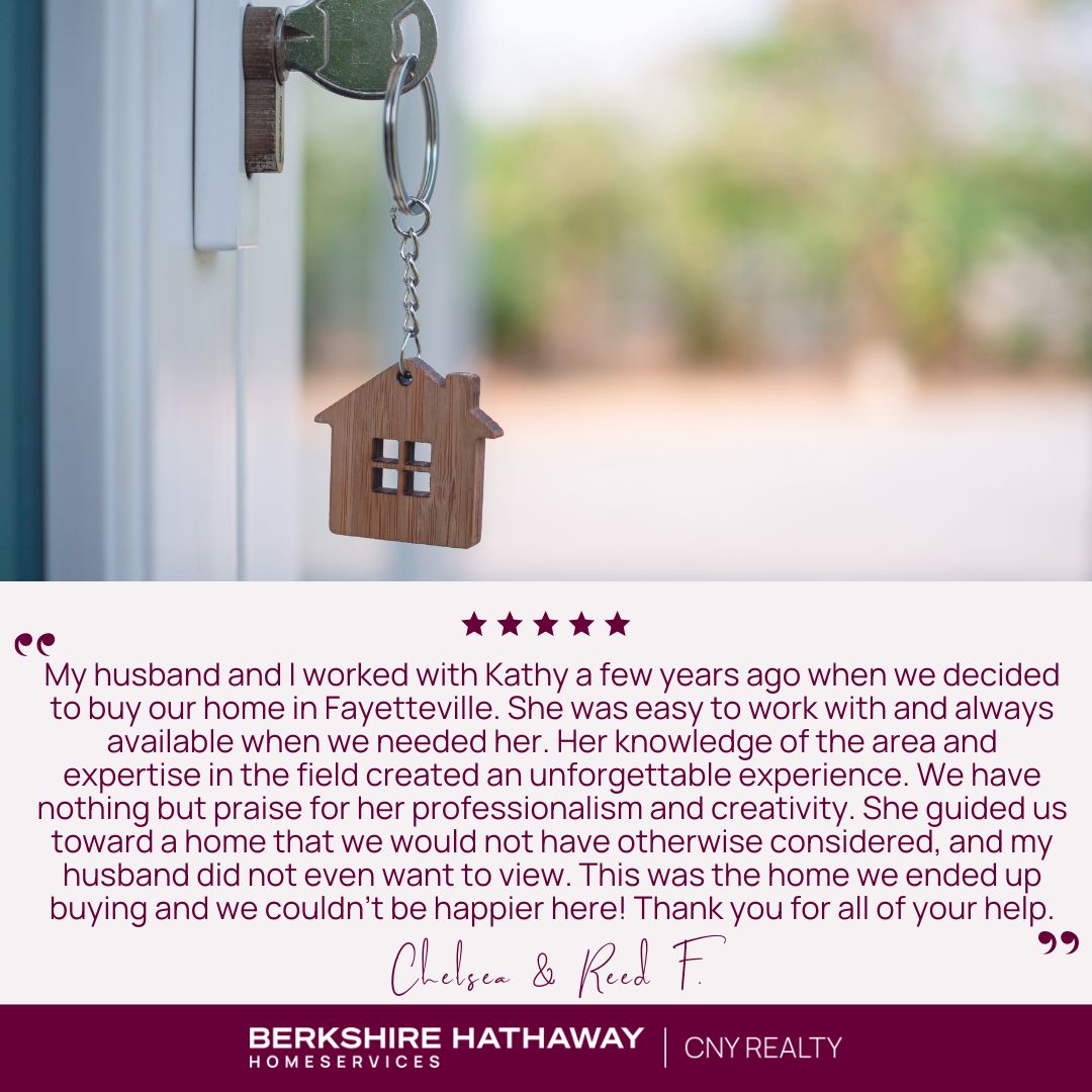 Front door of a home with a home-shaped keychain in the lock. Client review underneath