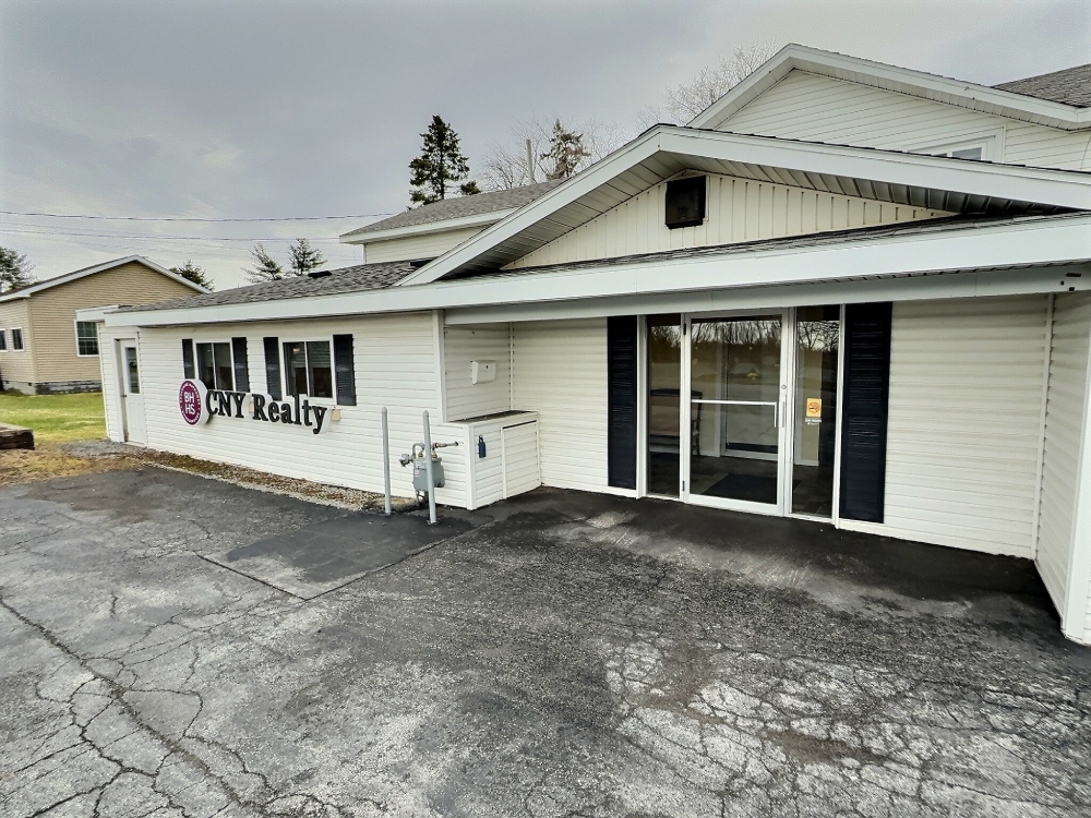 White building with a sign that says CNY Realty